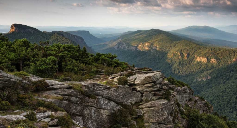 From a high elevation, the vast landscape of the Blue Ridge mountains stretches out for miles. 